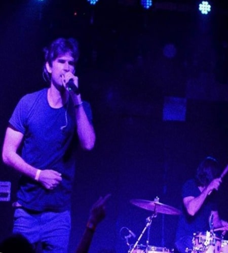 Blake Anderson Hanely is singing in a concert.